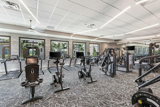 gym featuring visible vents, a paneled ceiling, and carpet floors