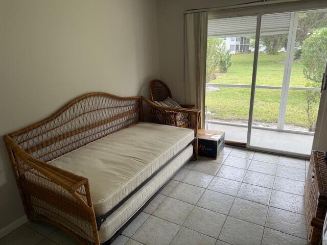 bedroom featuring access to outside and light tile patterned floors