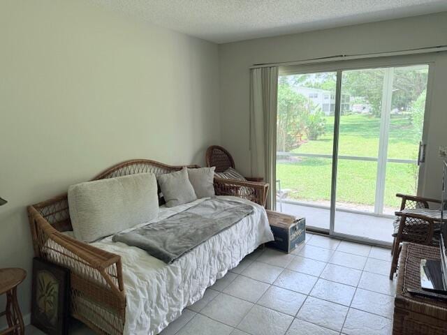 150 Newport J, Deerfield Beach, FL 33442 - bedroom with access to exterior, light tile patterned floors, and a textured ceiling