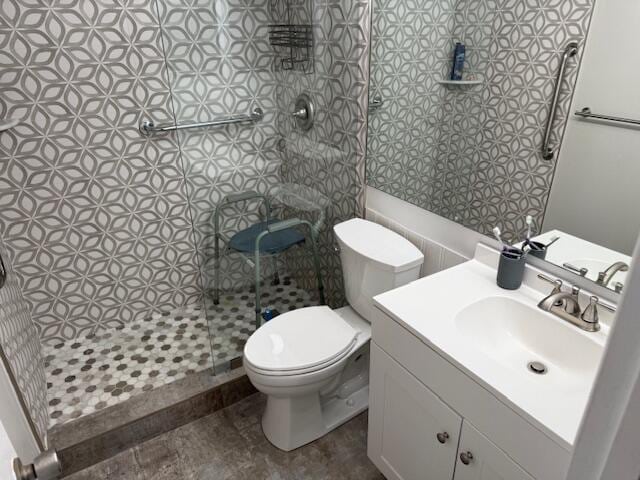 full bath with vanity, toilet, and a shower stall