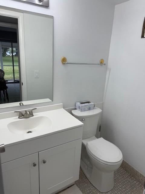 150 Newport J, Deerfield Beach, FL 33442 - bathroom with toilet, vanity, and tile patterned floors