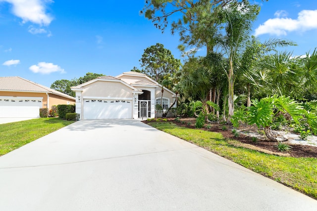 view of front of home featuring a tile roof, concrete driveway, a garage, and stucco siding