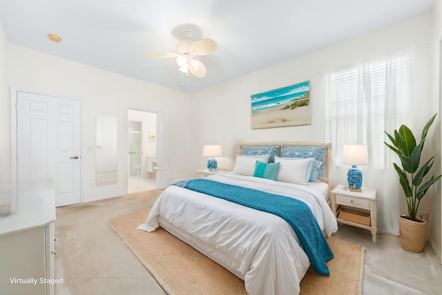 bedroom featuring a ceiling fan, ensuite bathroom, and light carpet