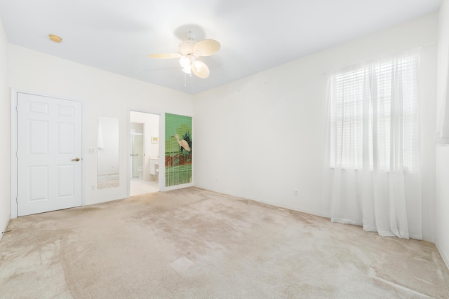 carpeted spare room with ceiling fan