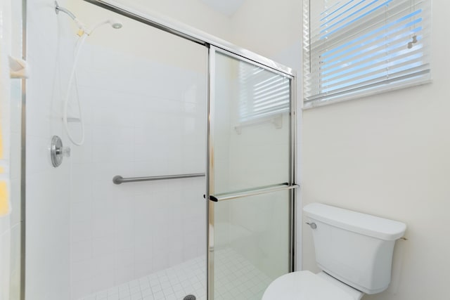 full bath with toilet and a stall shower