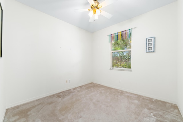 unfurnished room with baseboards, light colored carpet, and ceiling fan