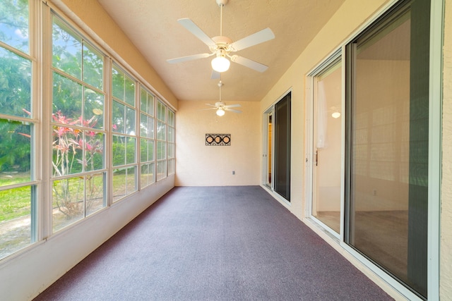 unfurnished sunroom featuring ceiling fan