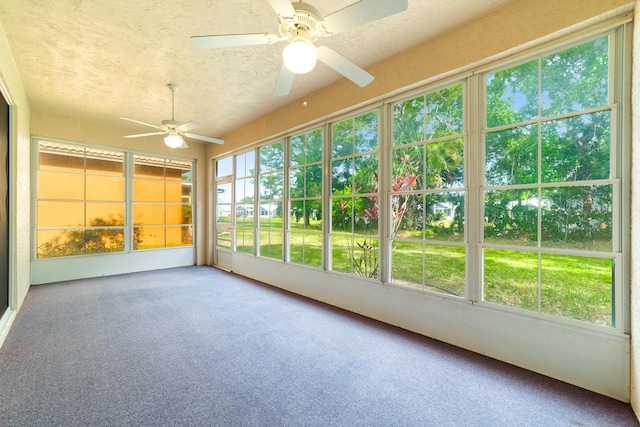 unfurnished sunroom featuring a ceiling fan