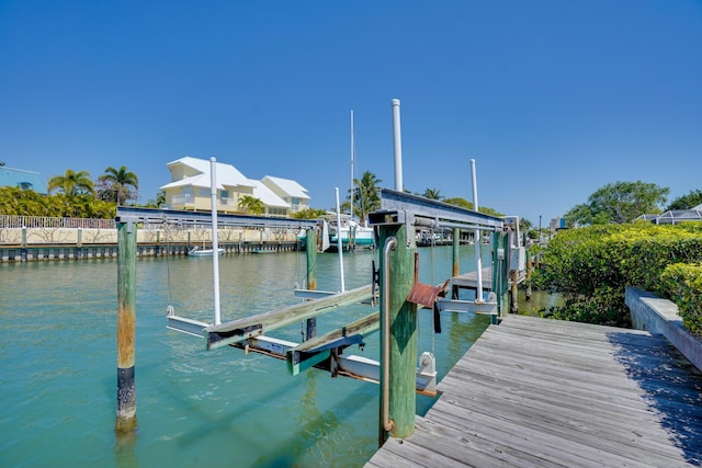 view of dock with boat lift and a water view