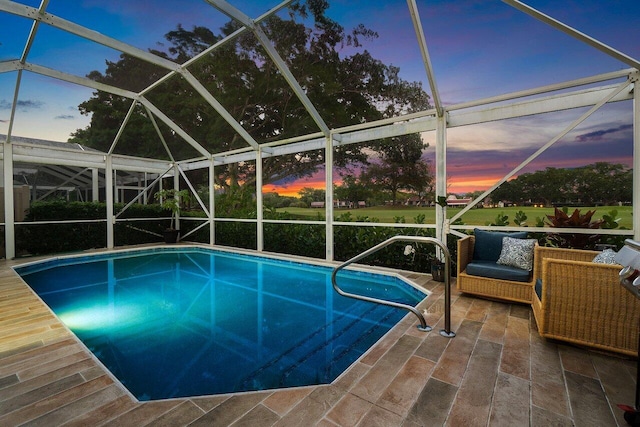 outdoor pool with a patio and a lanai