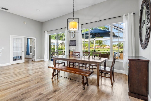 dining space with visible vents, baseboards, and light wood-style floors