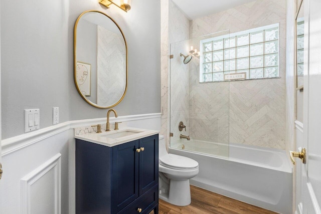 bathroom featuring shower / bath combination, toilet, wood finished floors, and vanity