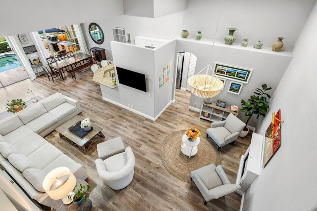 living room featuring a notable chandelier and wood finished floors