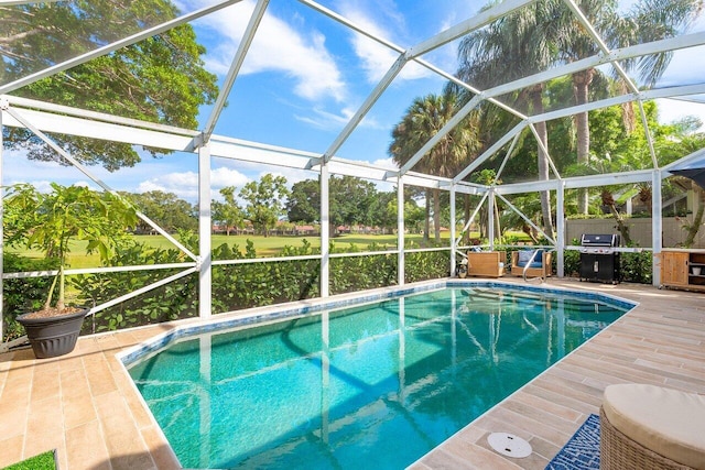 pool with a patio area and glass enclosure