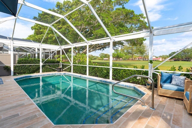 outdoor pool featuring glass enclosure and a patio