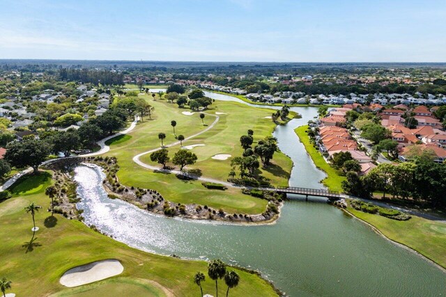 bird's eye view with a water view and golf course view