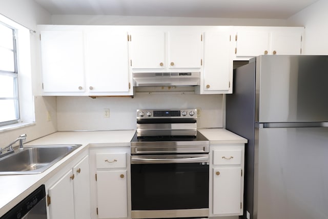 kitchen featuring under cabinet range hood, appliances with stainless steel finishes, white cabinets, and a sink