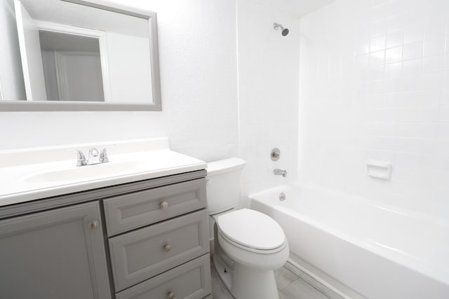 bathroom with vanity, shower / tub combination, and toilet