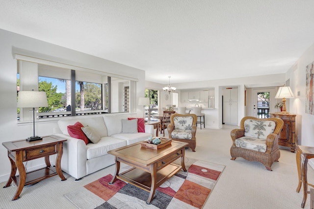 168 Brackenwood Rd, Palm Beach Gardens, FL 33418 - living area featuring light colored carpet and an inviting chandelier