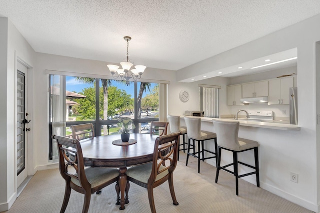 168 Brackenwood Rd, Palm Beach Gardens, FL 33418 - dining area featuring a textured ceiling, an inviting chandelier, baseboards, and light carpet