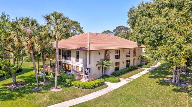 168 Brackenwood Rd, Palm Beach Gardens, FL 33418 - exterior space with a balcony, a lawn, and a tiled roof