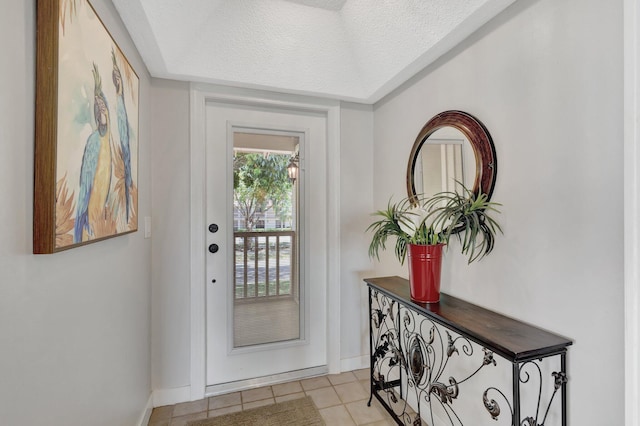 168 Brackenwood Rd, Palm Beach Gardens, FL 33418 - entryway featuring light tile patterned floors, a textured ceiling, and baseboards