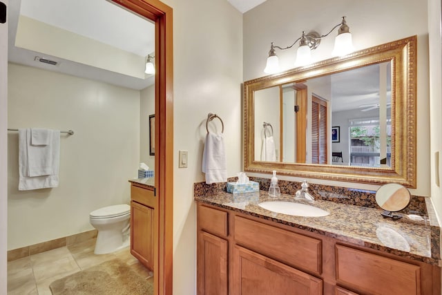 bathroom featuring visible vents, toilet, vanity, and tile patterned flooring