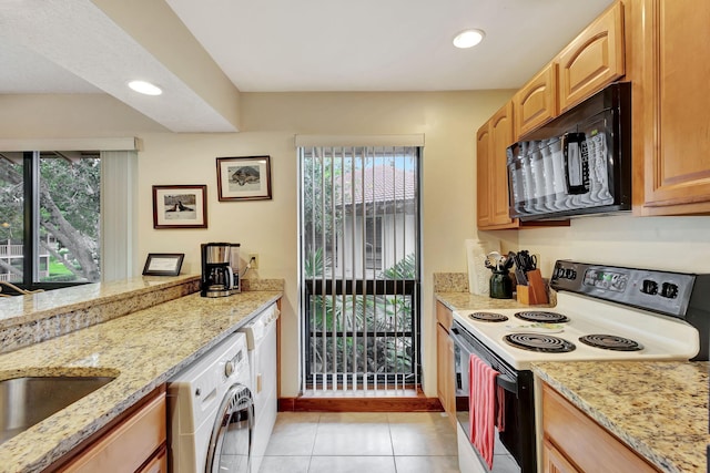 kitchen with range with electric cooktop, recessed lighting, black microwave, light stone countertops, and washer / dryer