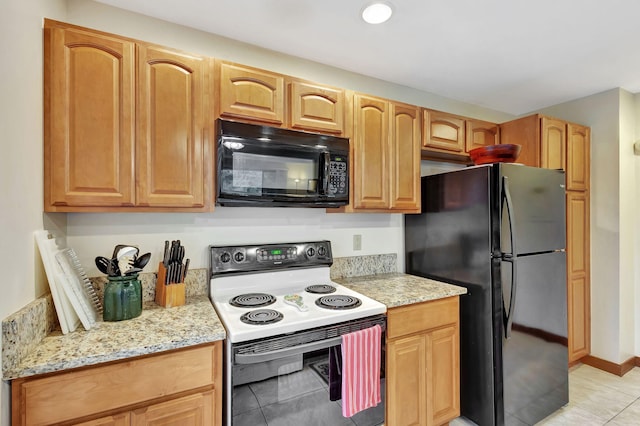 kitchen featuring black appliances, light tile patterned floors, and light stone countertops