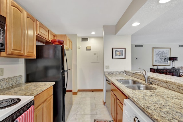 kitchen with visible vents, light stone countertops, light tile patterned floors, black appliances, and a sink