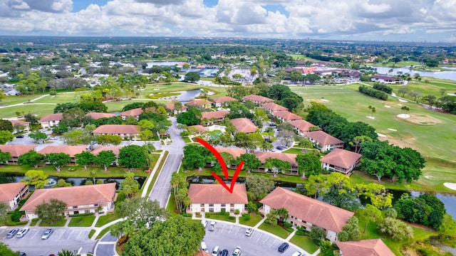 aerial view featuring a residential view, view of golf course, and a water view