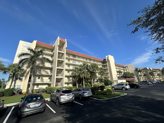 view of property featuring uncovered parking