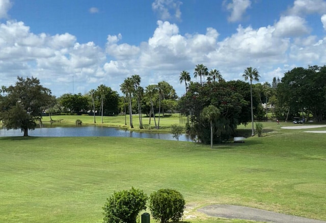 3871 Via Poinciana Unit 302, Lake Worth, FL 33467 - view of community featuring a yard, a water view, and view of golf course