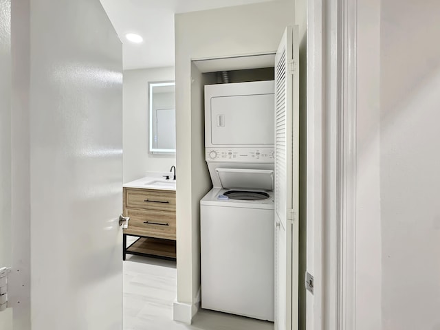 1335 Crystal Way Unit L, Delray Beach, FL 33444 - laundry room featuring stacked washing machine and dryer and recessed lighting