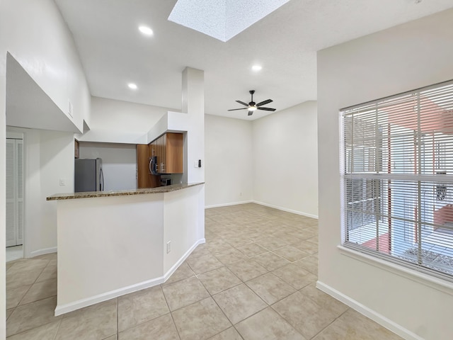 1335 Crystal Way Unit L, Delray Beach, FL 33444 - kitchen with stainless steel appliances, a skylight, light tile patterned floors, recessed lighting, and baseboards