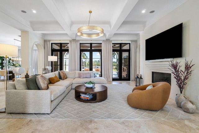 living room featuring a premium fireplace, beam ceiling, ornamental molding, an inviting chandelier, and coffered ceiling