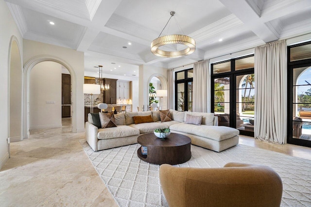 living area featuring beam ceiling, arched walkways, coffered ceiling, and an inviting chandelier