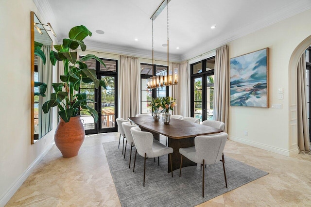 dining room with arched walkways, a chandelier, crown molding, and baseboards