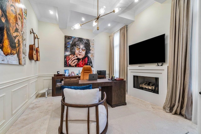 office area featuring a wainscoted wall, beamed ceiling, a fireplace, ornamental molding, and a decorative wall