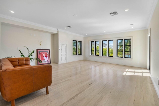 living room with light wood-style flooring, visible vents, and ornamental molding