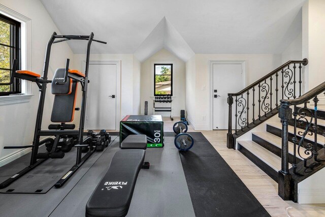 exercise room featuring baseboards and wood finished floors