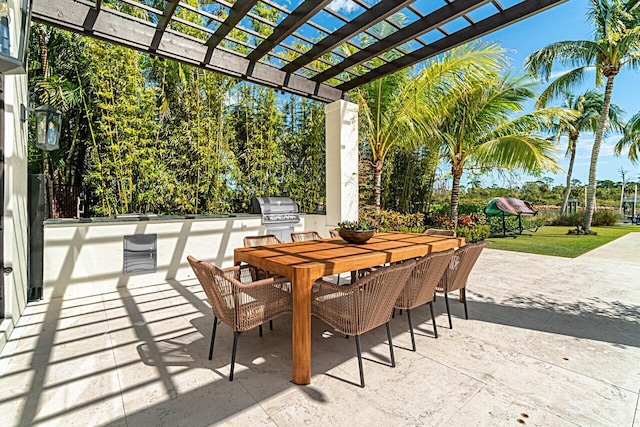 view of patio / terrace with area for grilling, outdoor dining space, a pergola, and exterior kitchen