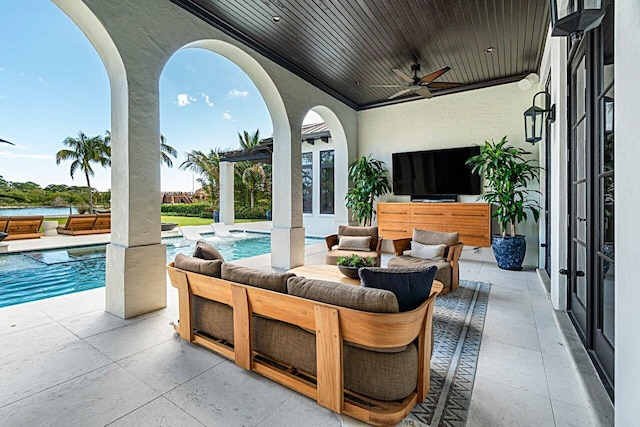 view of patio / terrace featuring an outdoor pool, ceiling fan, and outdoor lounge area