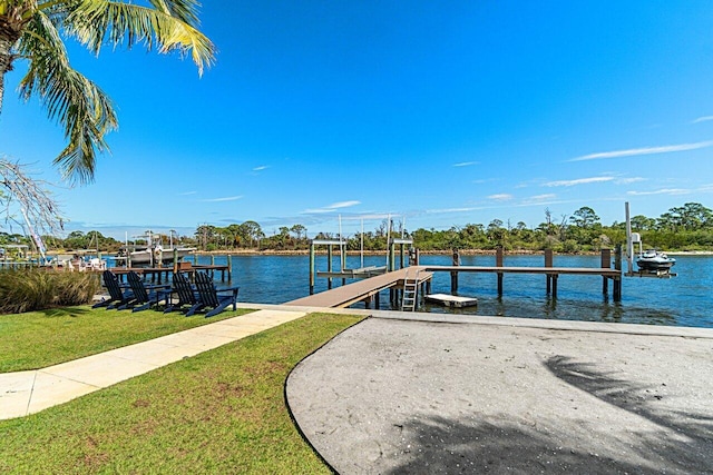 dock area featuring a yard, a water view, and boat lift