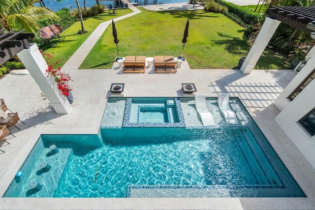 view of pool with a patio area, a pool with connected hot tub, outdoor lounge area, and a yard