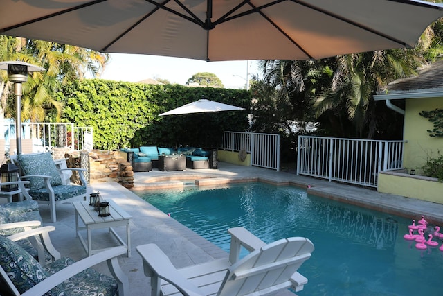 outdoor pool with an outdoor hangout area and a patio