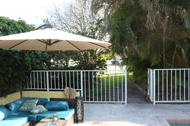 view of patio / terrace featuring an outdoor hangout area and a gate