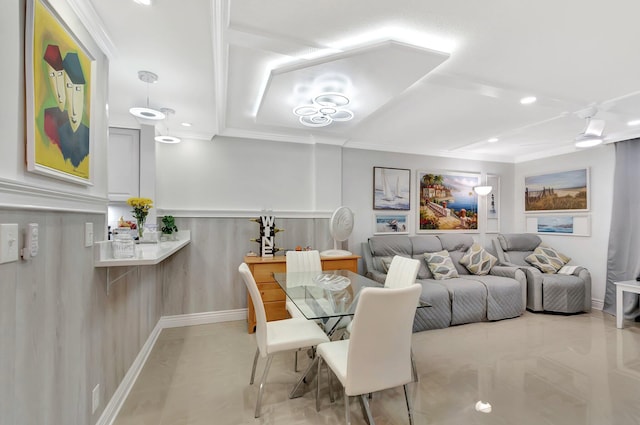 dining space with a wainscoted wall and ornamental molding