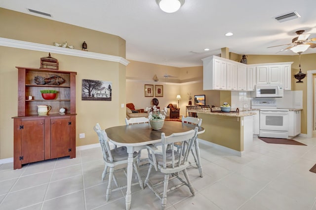 dining area with baseboards, visible vents, ceiling fan, and light tile patterned floors