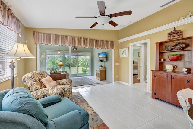 living room featuring visible vents, baseboards, ceiling fan, lofted ceiling, and light tile patterned floors
